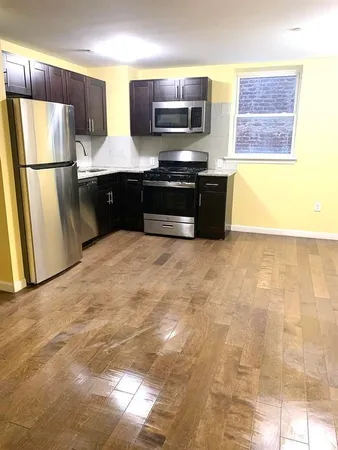 a kitchen with stainless steel appliances a refrigerator and a stove top oven