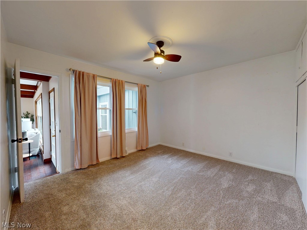 162 South Leavitt Road Amherst, OH 44001 - Photo 26 of 41 Empty room with a ceiling fan and light carpet