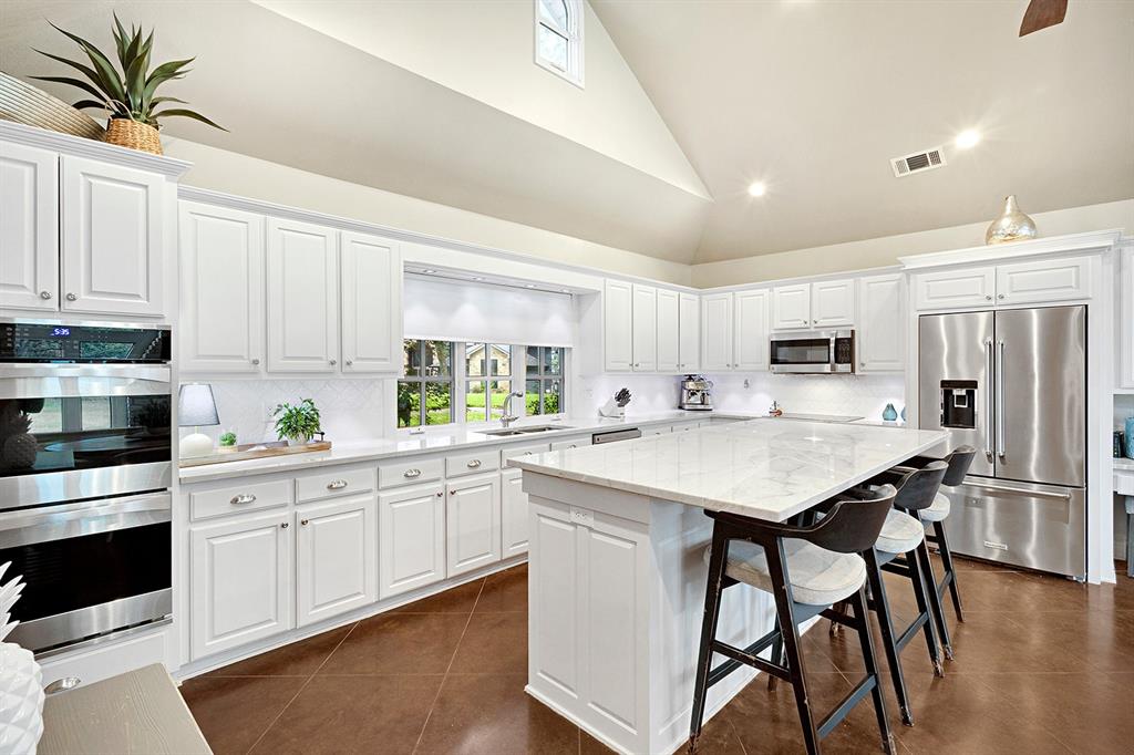 103 Glenn Road Mabank, TX 75156 - Photo 10 of 38 a kitchen with stainless steel appliances a white cabinets wooden floors and a sink