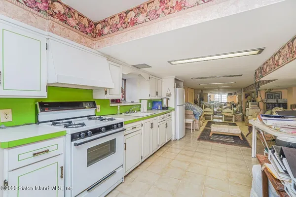 a kitchen with stainless steel appliances a stove a sink and a refrigerator