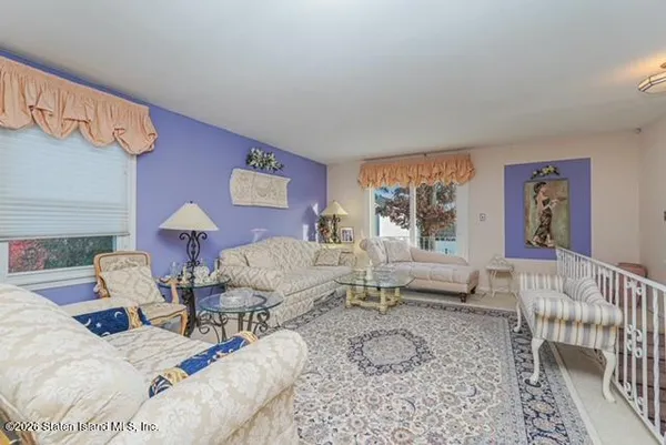 a living room with furniture chess table and a large window