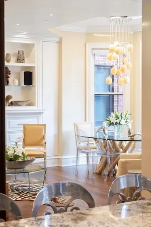 a living room with dining table and chairs