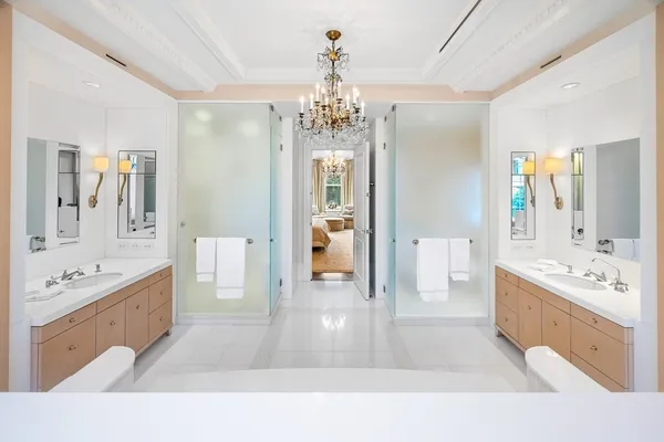 a spacious bathroom with a tub sink and mirror