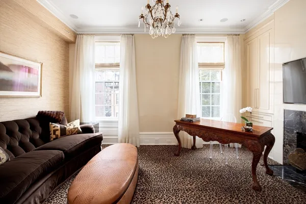 a living room with furniture a chandelier and a window
