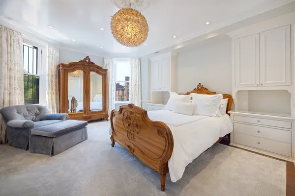 a spacious bedroom with a bed and a couch