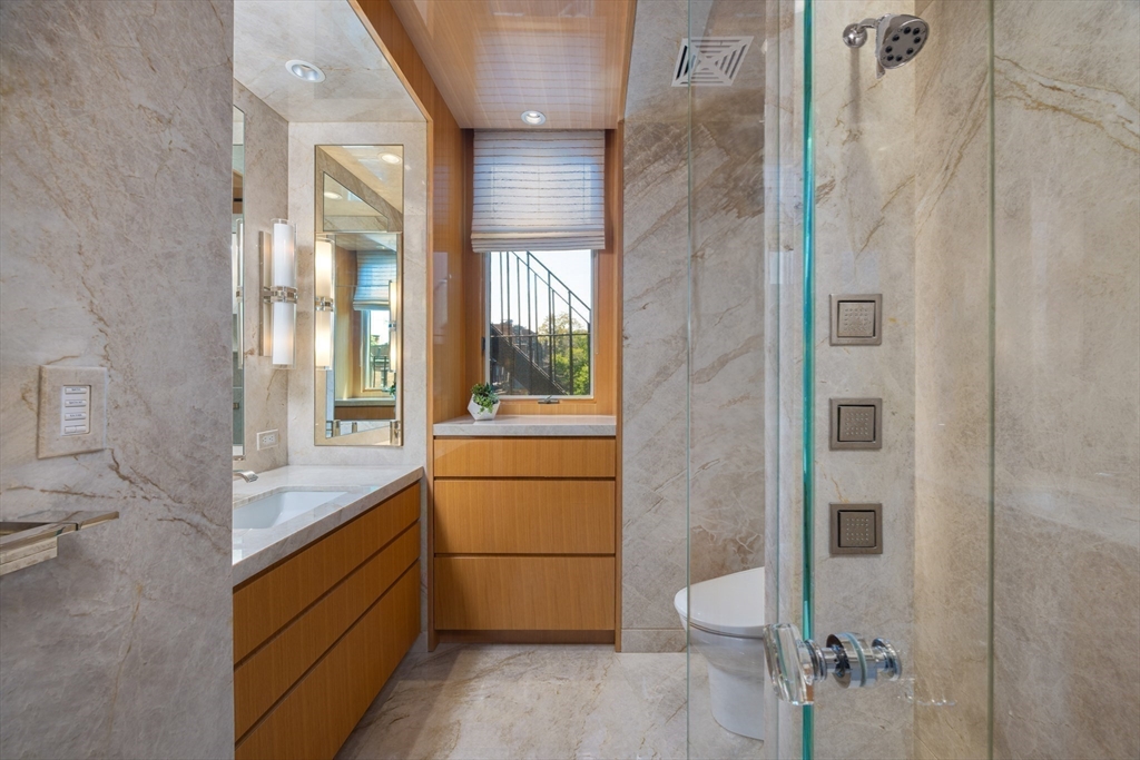 4 Gloucester Street Boston, MA 02115 - Photo 24 of 32 a bathroom with a sink a toilet and shower