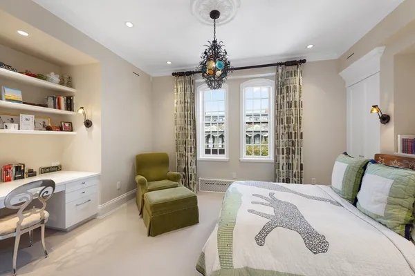a bedroom with a bed couch and window