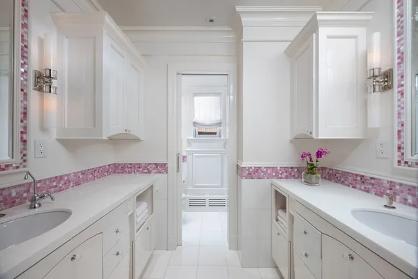 a bathroom with a sink vanity granite tub and a mirror