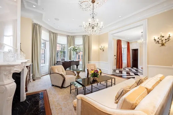 a living room with furniture and a chandelier