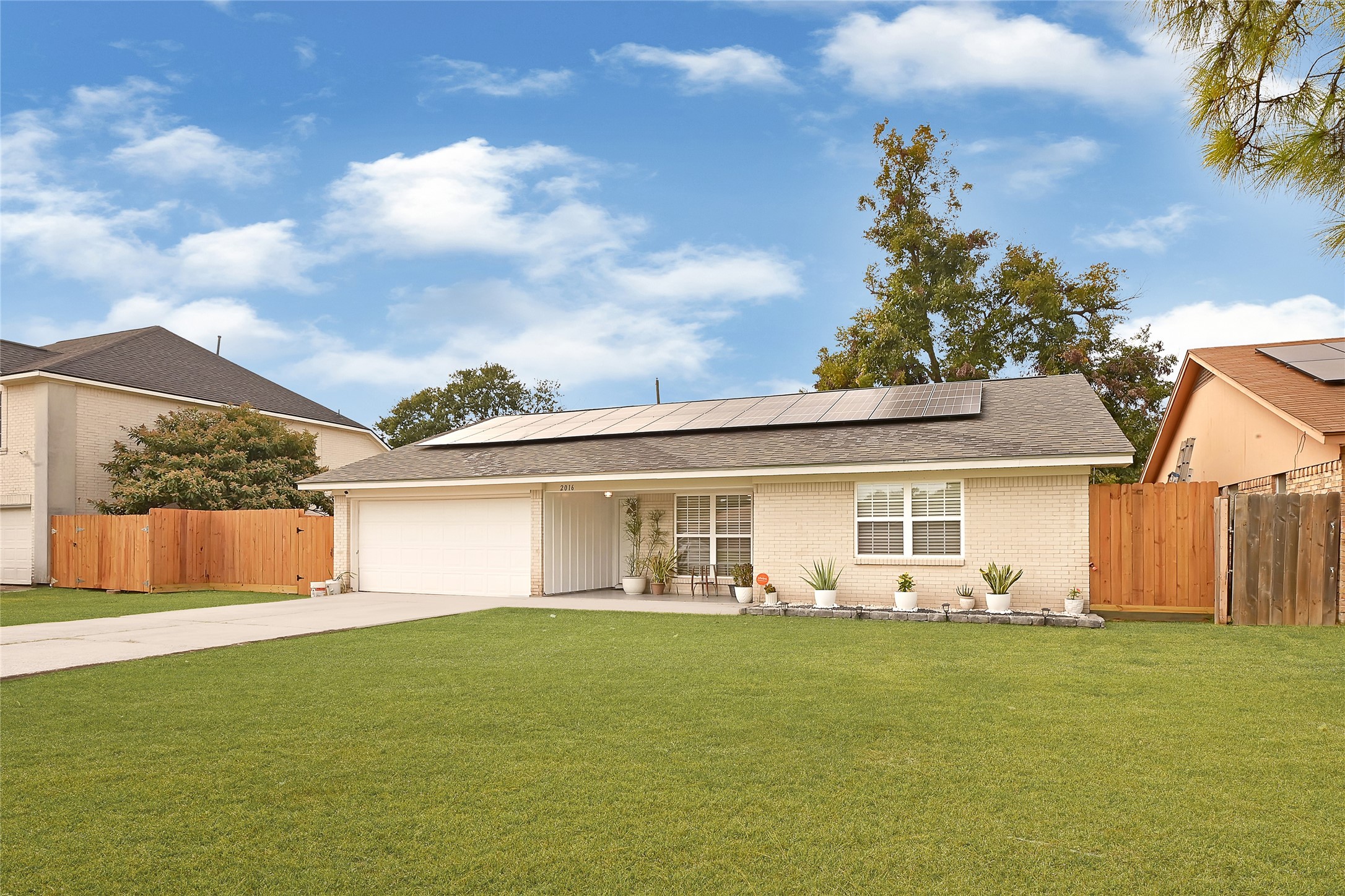 a front view of a house with garden