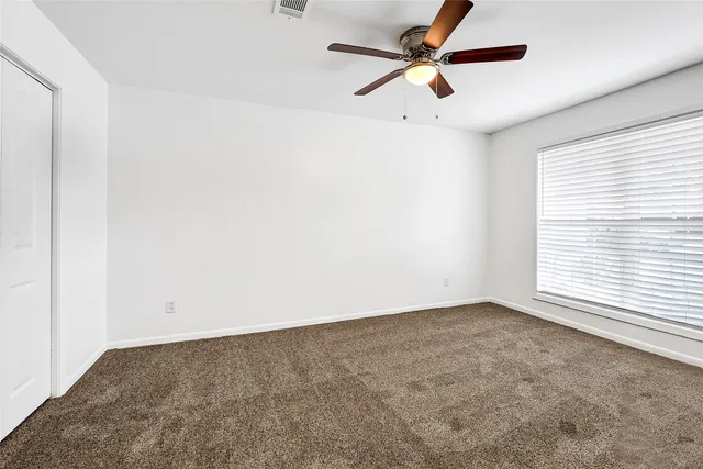 a bedroom with a bed and a television