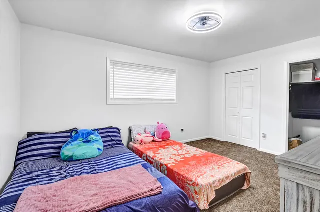 a bedroom with a bed and a television