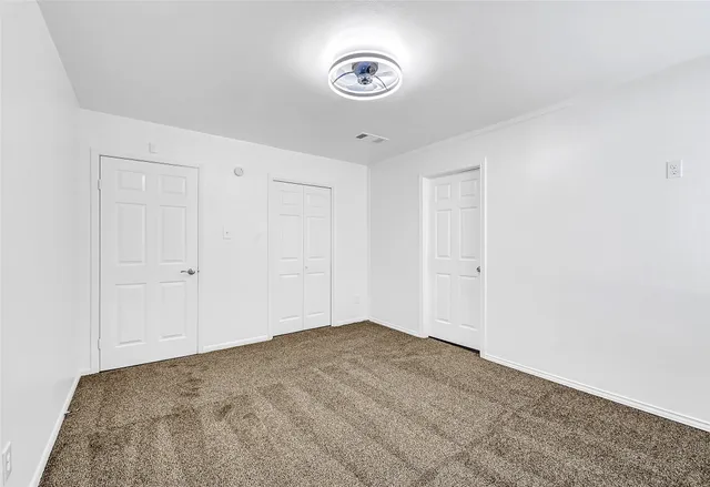 a white toilet sitting next to a white sink