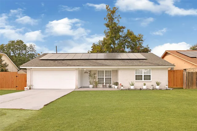 a front view of house with yard seating and green space
