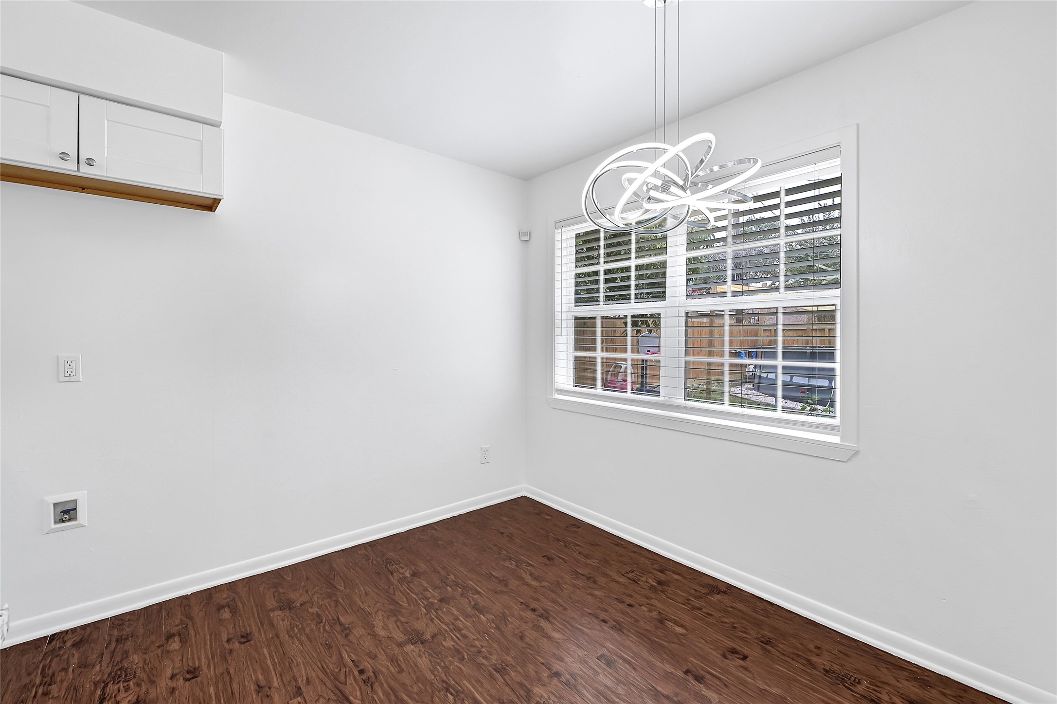 2016 South Houston Road Pasadena, TX 77502 - Photo 22 of 24 an empty room with wooden floor cabinets and windows