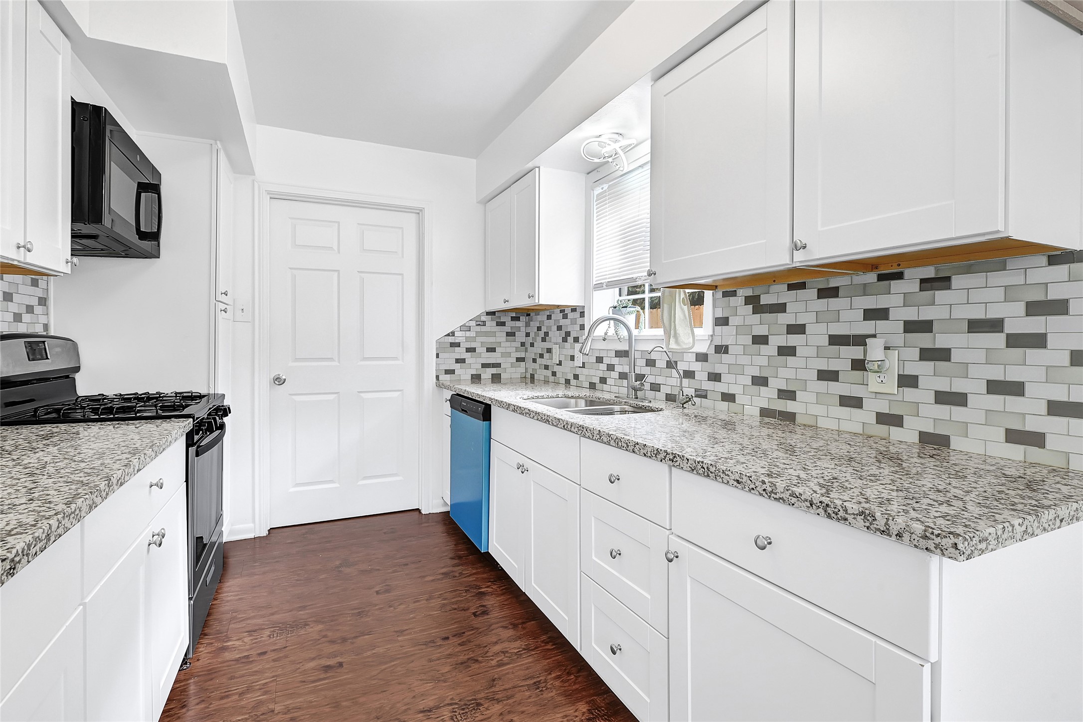 2016 South Houston Road Pasadena, TX 77502 - Photo 8 of 24 a kitchen with granite countertop white cabinets and a stove