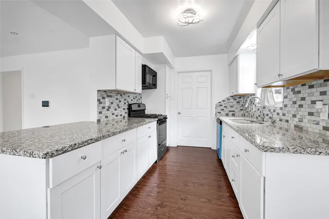 a kitchen with stainless steel appliances wooden cabinets stove and microwave