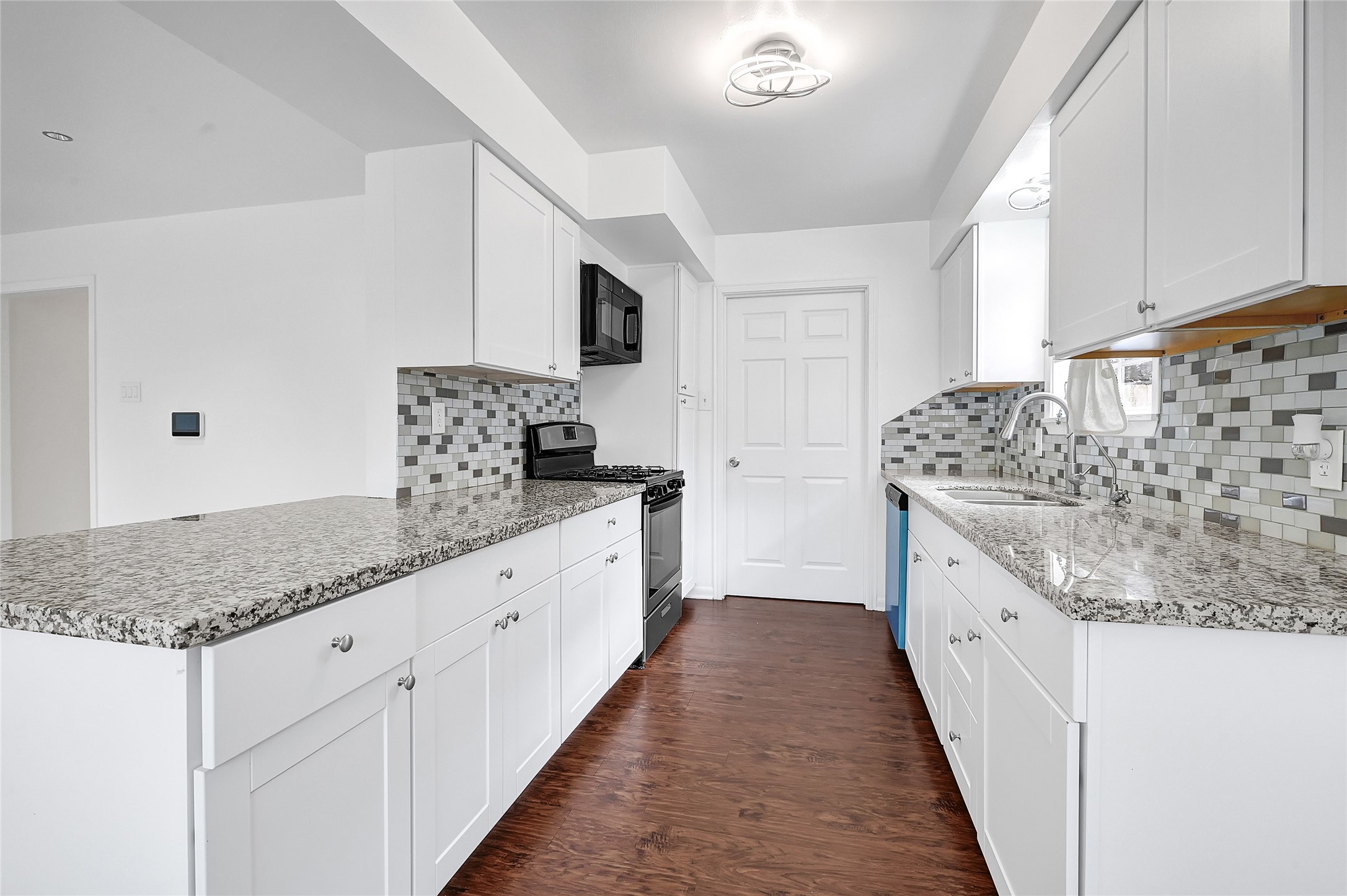 2016 South Houston Road Pasadena, TX 77502 - Photo 9 of 24 a bathroom with stainless steel appliances granite countertop a sink and dishwasher with white cabinets
