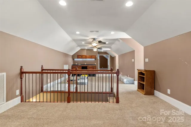 an empty room with ceiling fan and fan