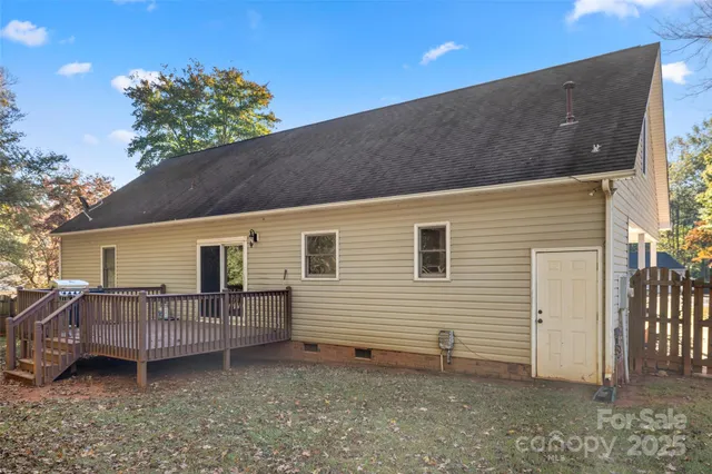 a view of house with a yard and sitting area