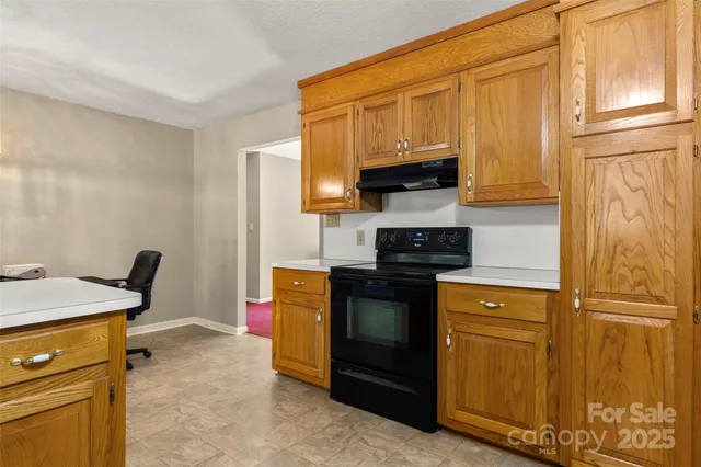 a kitchen with stainless steel appliances granite countertop a refrigerator stove and sink