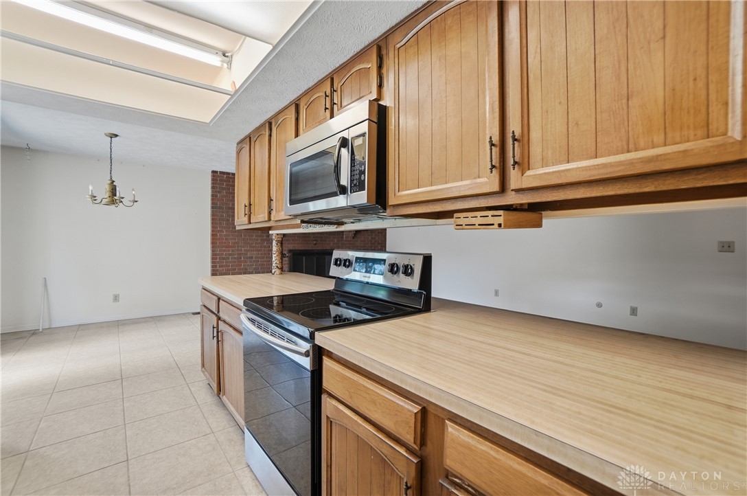 9964 Hummingbird Way Dayton, OH 45458 - Photo 16 of 57 This spacious kitchen offers ample cabinetry and an electric range, perfect for daily living.