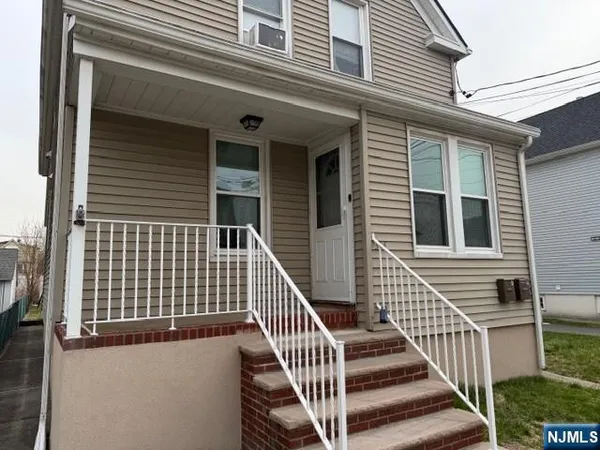 a view of a house with wooden fence