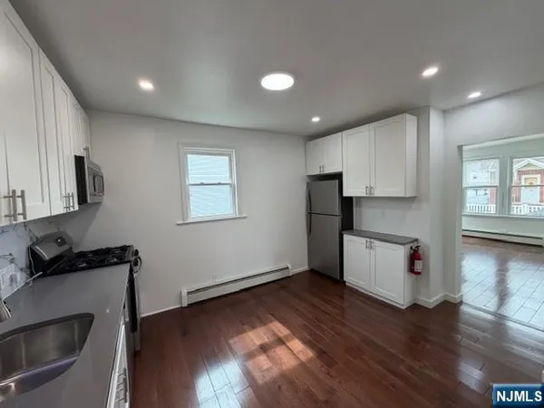 a kitchen with a refrigerator and a stove top oven