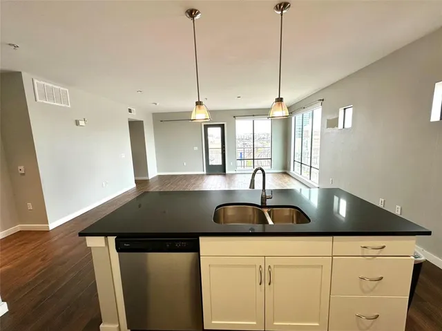 a spacious bathroom with a sink a toilet a shower and a mirror