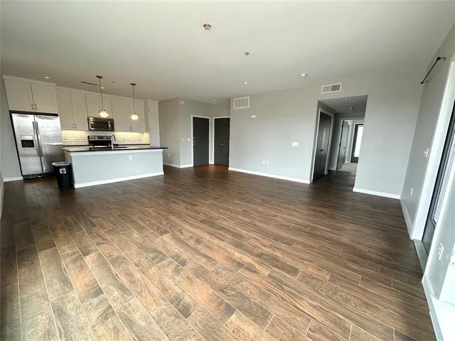 a kitchen with a sink a counter space and a window