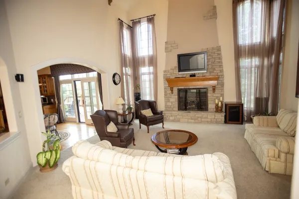 a living room with furniture a fireplace and a flat screen tv