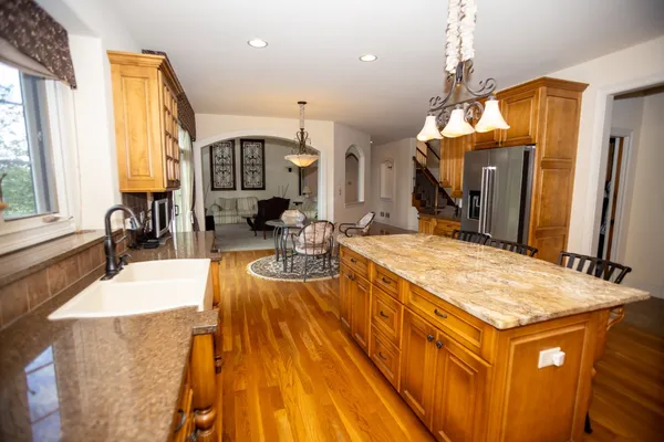 a spacious bathroom with a granite countertop sink and a large mirror