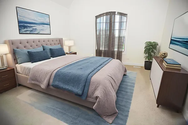 a bedroom with a bed and a potted plant