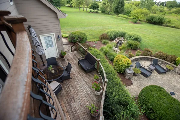 a backyard of a house with lots of green space and outdoor seating