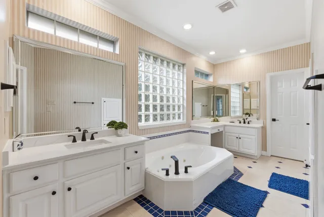 a bathroom with a sink a tub and a mirror
