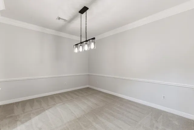 a view of a livingroom with a ceiling fan & windows