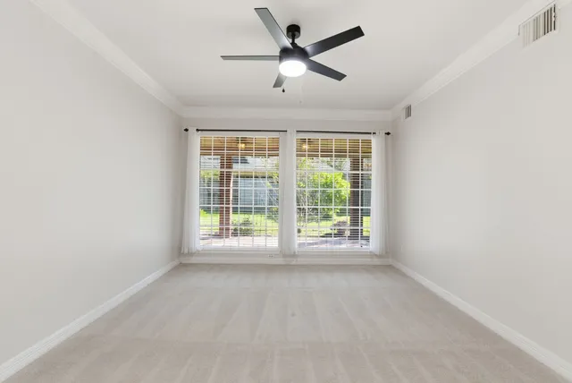 a view of an empty room with a fireplace and a window