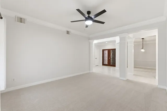 a view of an empty room with a fireplace and a window