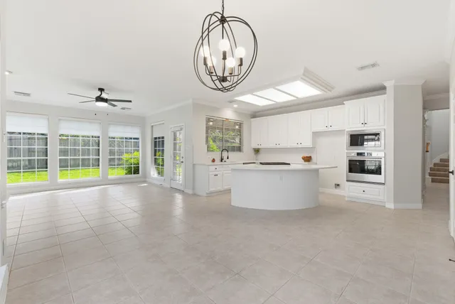 a kitchen with white cabinets and a stove top oven