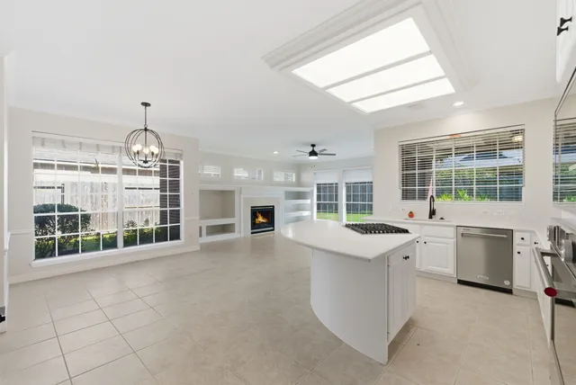 a bathroom with a bathtub a double vanity sink a window a mirror and shower