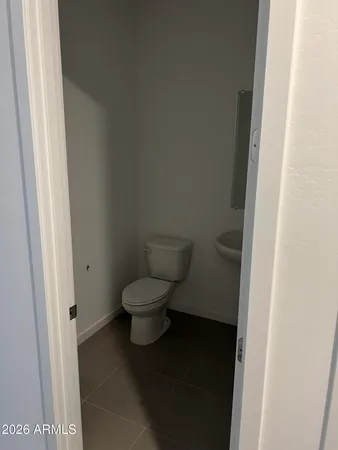 a white toilet sitting next to a sink