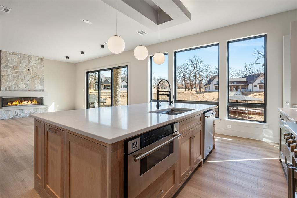 116 Pinnacle Club Drive Mabank, TX 75156 - Photo 11 of 40 a kitchen with a stove a sink a large window and wooden floor
