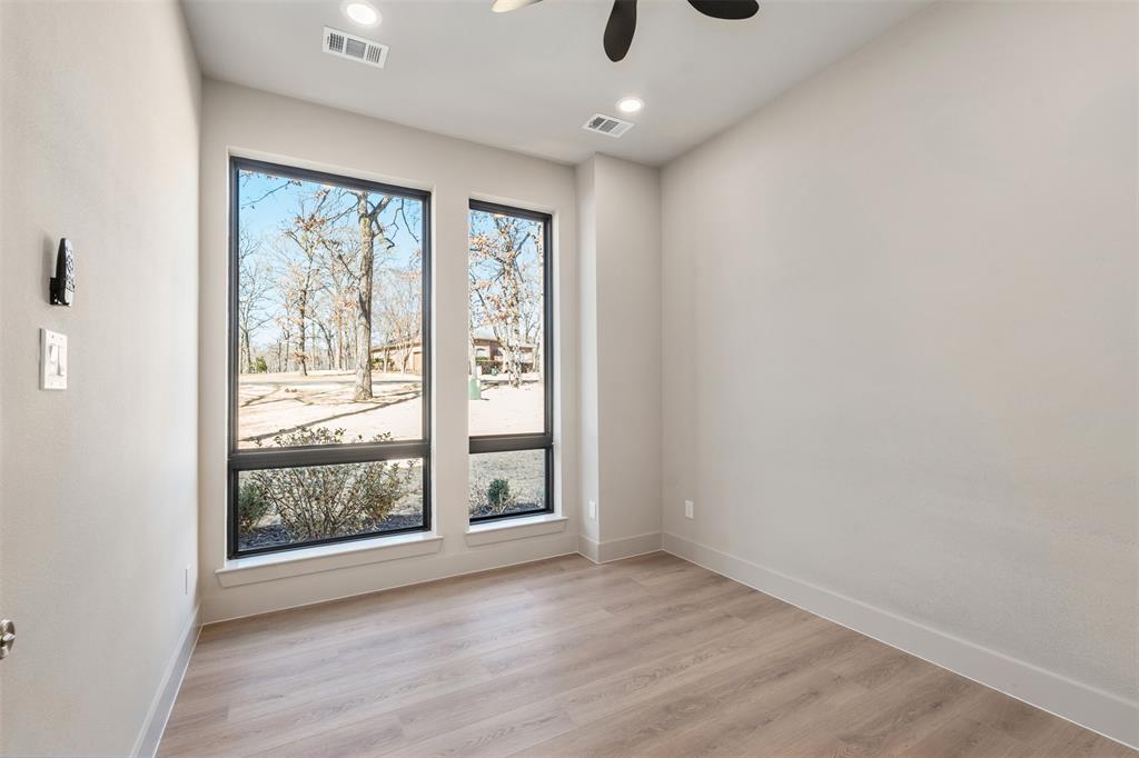 116 Pinnacle Club Drive Mabank, TX 75156 - Photo 8 of 40 an empty room with wooden floor and windows