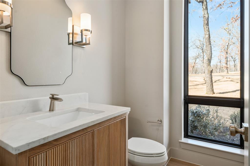 116 Pinnacle Club Drive Mabank, TX 75156 - Photo 9 of 40 a bathroom with a sink vanity mirror and toilet