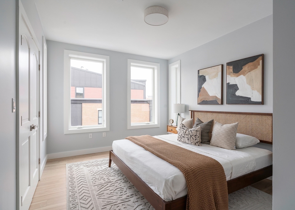 181 Maverick Street, Unit PH Boston, MA 02128 - Photo 11 of 20 a bedroom with a bed and a painting on the wall