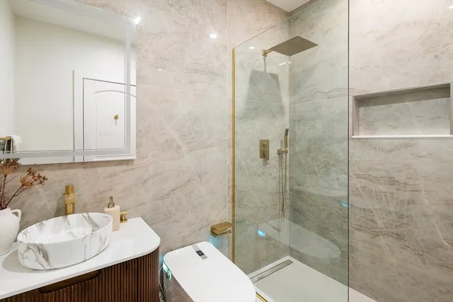 a bathroom with a sink toilet and shower