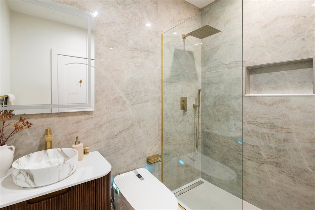 181 Maverick Street, Unit PH Boston, MA 02128 - Photo 12 of 20 a bathroom with a sink toilet and shower