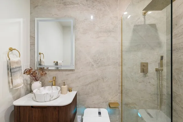 a bathroom with a sink toilet and shower