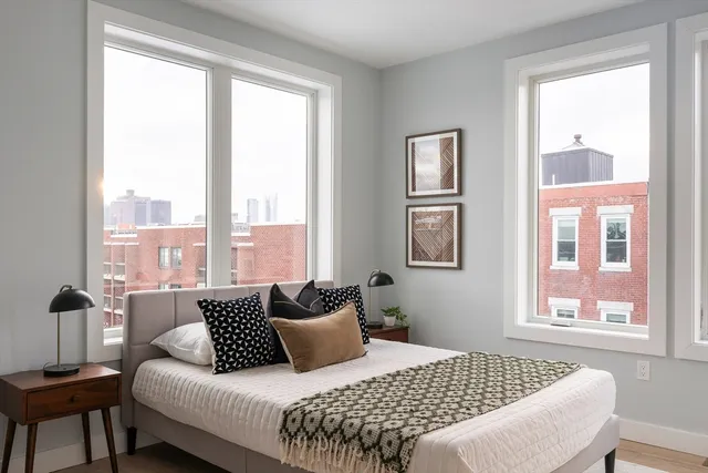 a bedroom with a bed and wooden floor