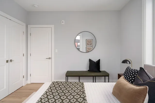 a bedroom with bed and a chair